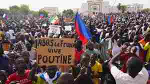 Supporters of Niger's coup march, waving Russian flags and denouncing France