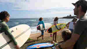 Maui's surf pros paddle out with kids from Lahaina for a healing surf session