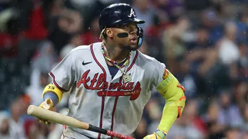 Braves' Ronald Acuña Jr knocked over in wild scene at Coors Field as security wrestles fans wanting hug