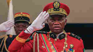 A Gabon military leader is sworn in after a coup, promising eventual elections