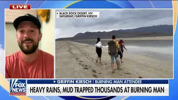 Burning Man festival attendee treks through ankle-deep mud to escape: 'Our only option to get out'