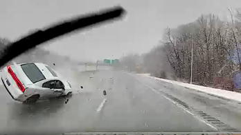 Massachusetts ambulance driver narrowly avoids highway rollover crash in front of him: video