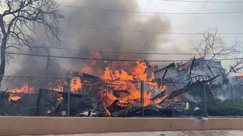 More than 100 firefighters tackle abandoned building blaze that spread to hotel