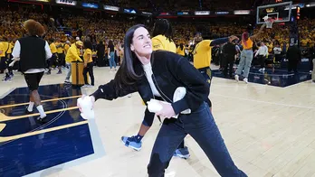 WNBA star Caitlin Clark autographs ultrasound photo during appearance at Pacers playoff game