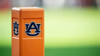 Auburn cheerleader knocks down Oklahoma player running onto field while performing stunts