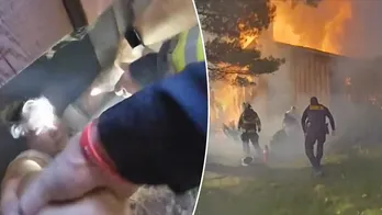 Ohio woman pulled to safety from basement while home above her engulfed in flames, bodycam shows